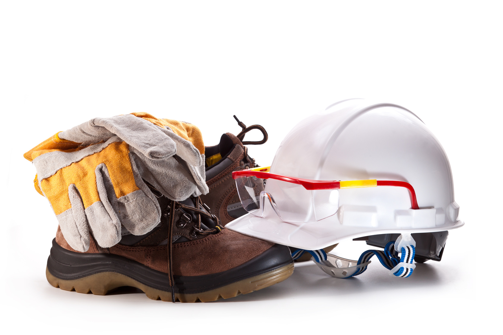 White hard hat with goggles, boots, and gloves on a white background